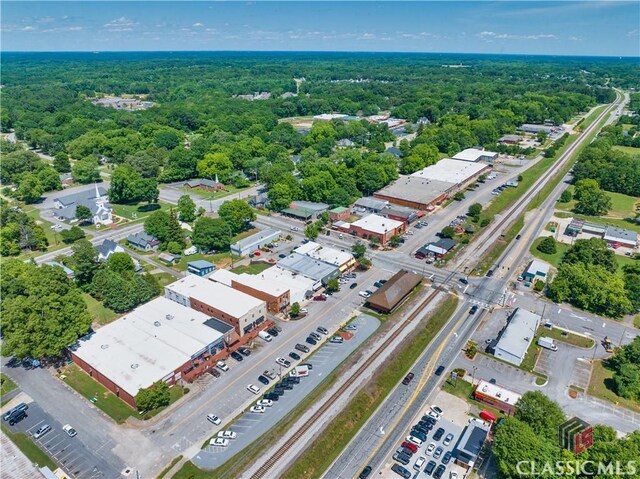 birds eye view of property with a wooded view