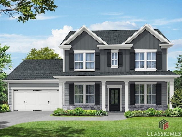 craftsman house featuring a garage and a front lawn