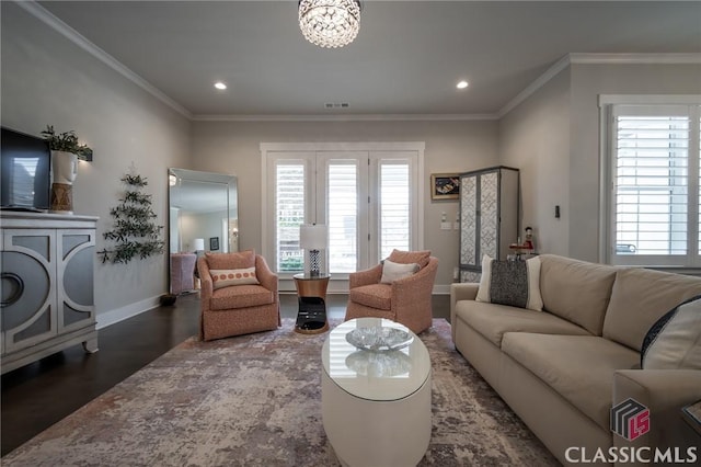 living room featuring ornamental molding, dark wood-type flooring, and a notable chandelier