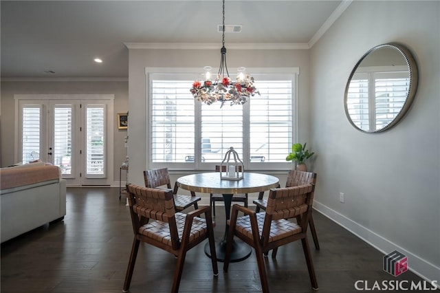 dining space with an inviting chandelier, dark wood-type flooring, and ornamental molding