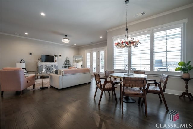 dining area with ornamental molding, dark hardwood / wood-style floors, a wealth of natural light, and french doors