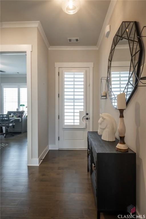 doorway to outside with dark hardwood / wood-style flooring, crown molding, and a wealth of natural light