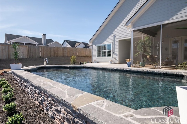 view of swimming pool featuring a patio area and a sunroom