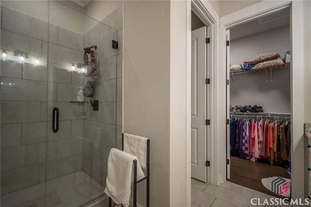 bathroom featuring an enclosed shower and tile patterned floors