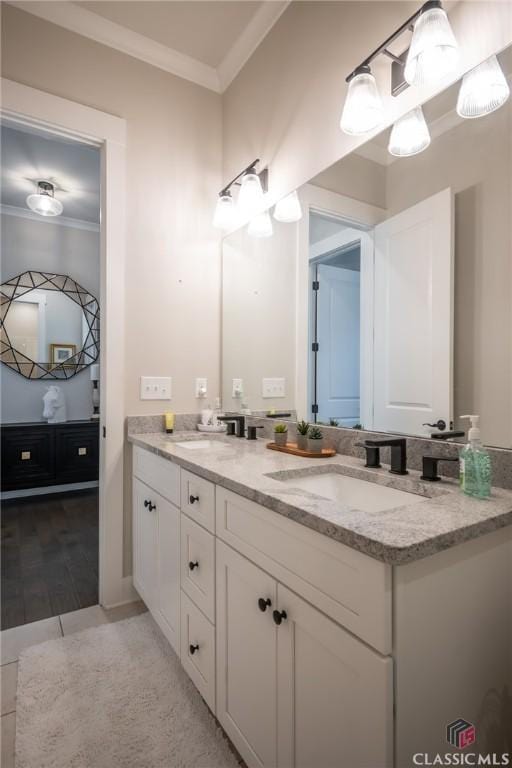 bathroom with crown molding, vanity, and tile patterned floors