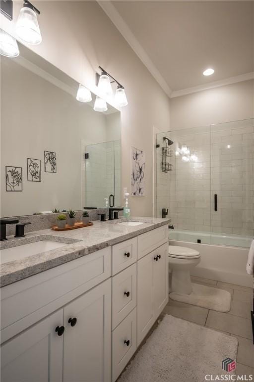 full bathroom with vanity, bath / shower combo with glass door, ornamental molding, and toilet