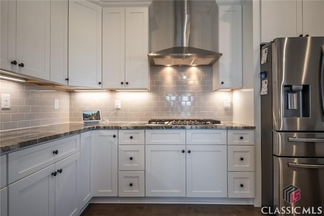 kitchen with stainless steel appliances, wall chimney exhaust hood, and white cabinets