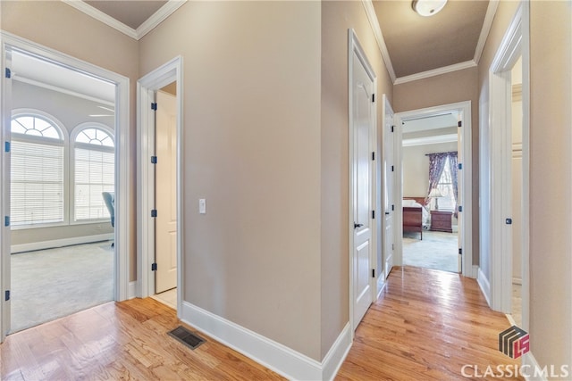 hall featuring crown molding and light wood-type flooring