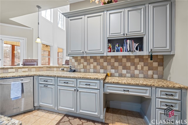 kitchen featuring light stone counters, light tile patterned floors, ornamental molding, and stainless steel dishwasher