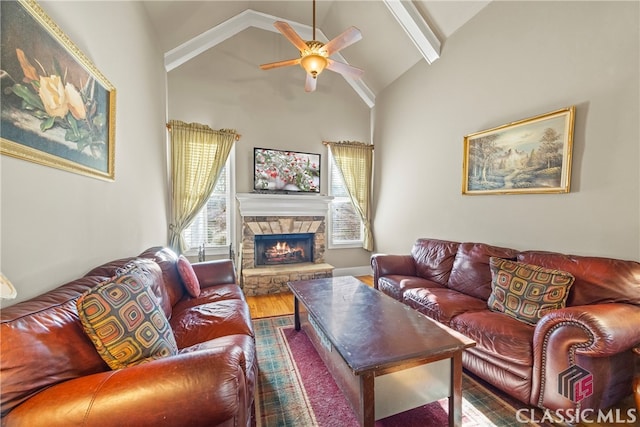 living room with a stone fireplace, wood-type flooring, high vaulted ceiling, ceiling fan, and beam ceiling