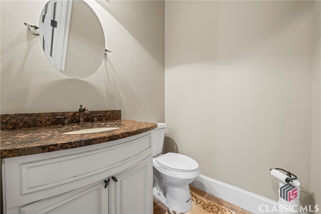 bathroom with vanity, toilet, and tile patterned flooring