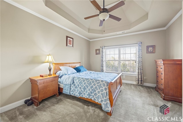 bedroom with ceiling fan, ornamental molding, a raised ceiling, and carpet floors