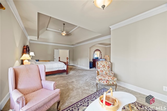 carpeted bedroom featuring ornamental molding, a raised ceiling, and ceiling fan