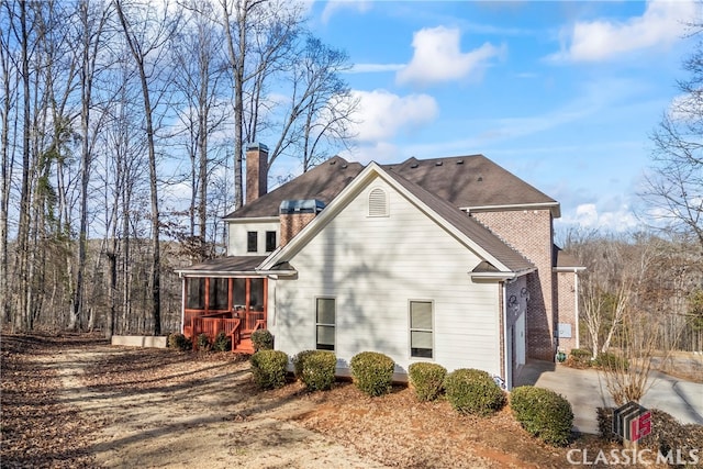 view of side of property with a sunroom