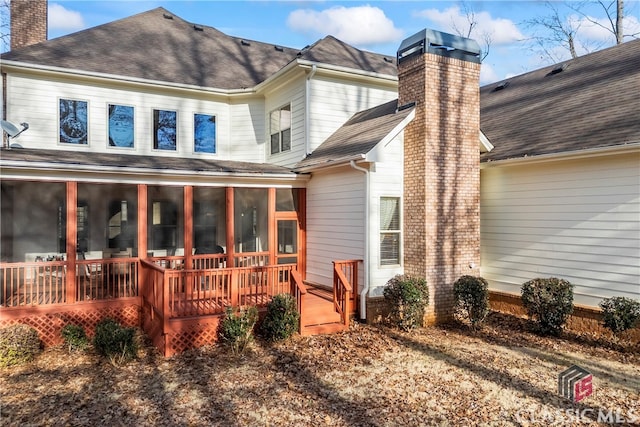 back of house with a sunroom and a deck