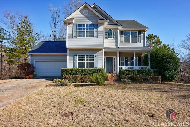 view of front facade featuring a garage, a front lawn, and a porch