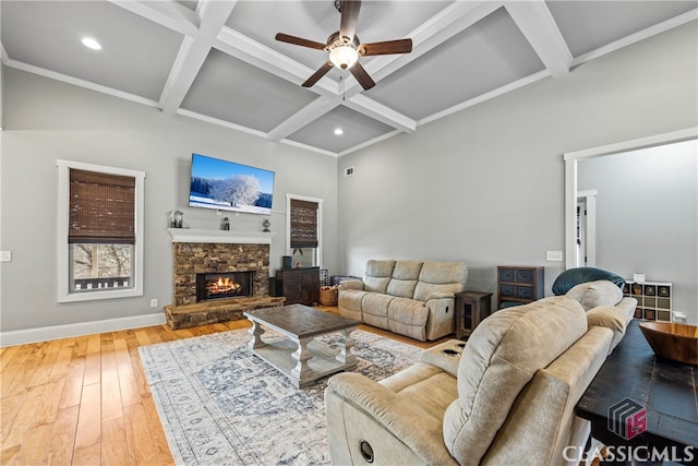 living room with ceiling fan, coffered ceiling, a fireplace, wood-type flooring, and beamed ceiling