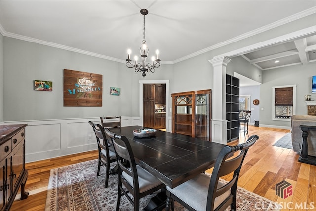 dining area featuring beamed ceiling, crown molding, light hardwood / wood-style floors, and decorative columns