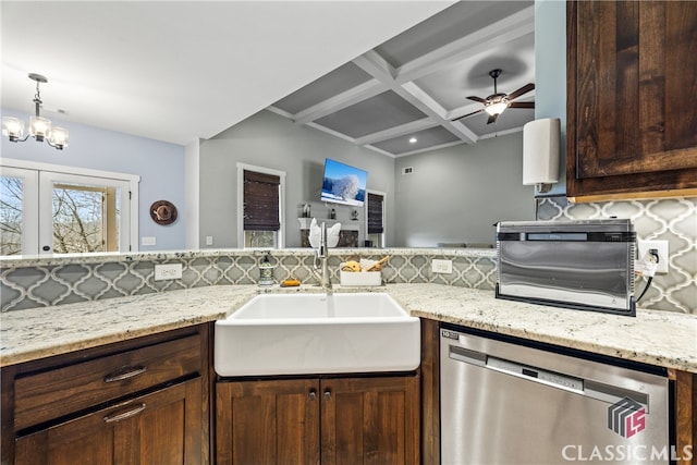 kitchen featuring sink, dishwasher, coffered ceiling, light stone countertops, and decorative backsplash