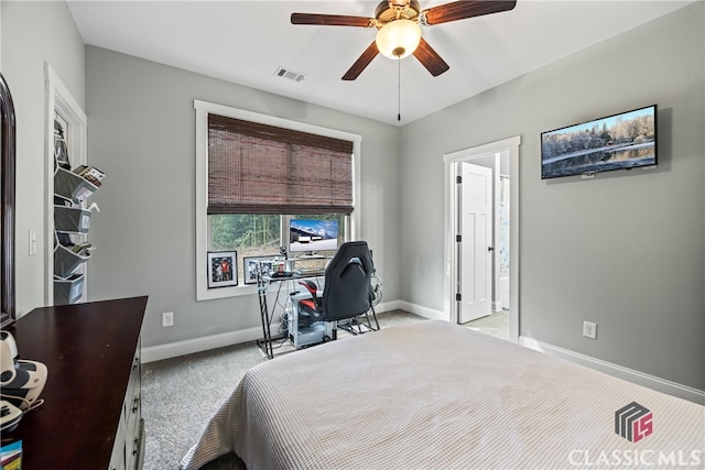 carpeted bedroom featuring ceiling fan and ensuite bathroom