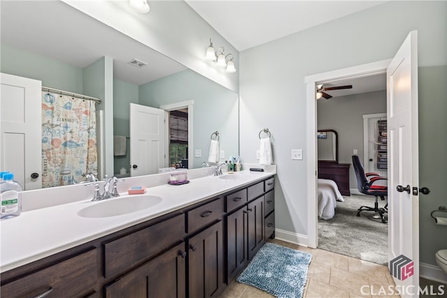 bathroom featuring tile patterned flooring, vanity, toilet, and ceiling fan