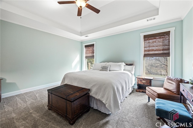 bedroom featuring carpet floors, ornamental molding, a raised ceiling, and ceiling fan