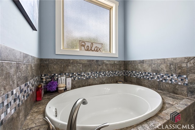 bathroom featuring a tub and plenty of natural light