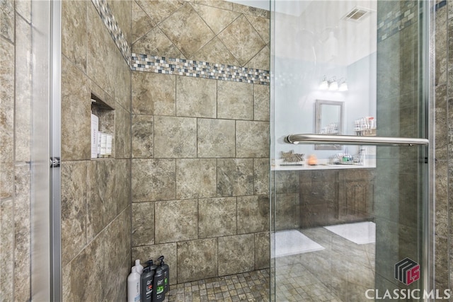 bathroom with a shower with door