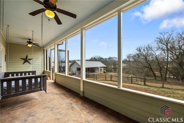 sunroom featuring ceiling fan