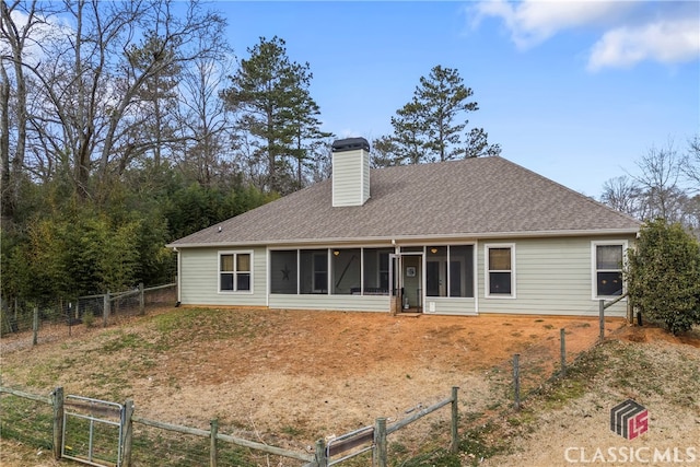 rear view of property featuring a sunroom