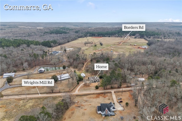 birds eye view of property featuring a rural view