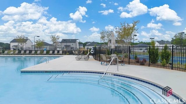 view of swimming pool with a patio