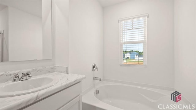 bathroom with vanity and a bathtub