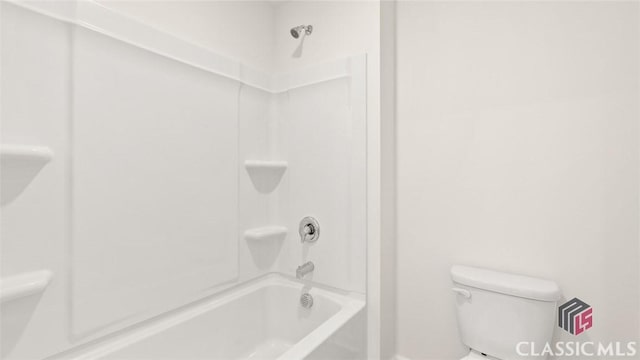 bathroom featuring shower / washtub combination and toilet