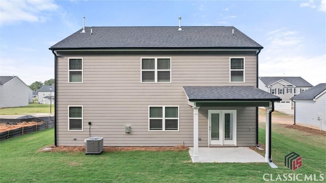 back of house featuring a lawn, central air condition unit, and a patio area