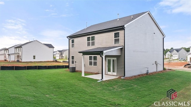 back of property featuring a yard, central AC unit, and a patio