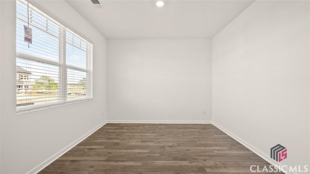 unfurnished room with dark hardwood / wood-style flooring