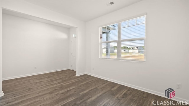 unfurnished room with dark hardwood / wood-style floors