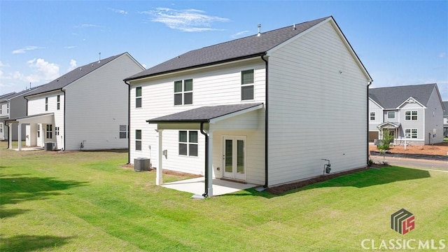 rear view of house featuring a patio, a yard, and central air condition unit