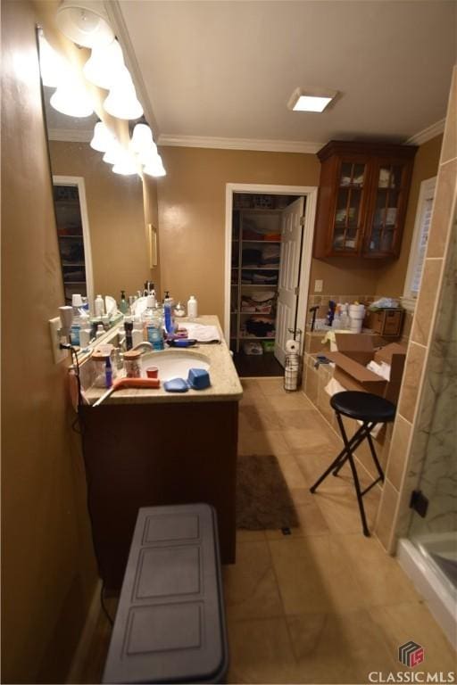 bathroom with ornamental molding, vanity, a chandelier, and walk in shower