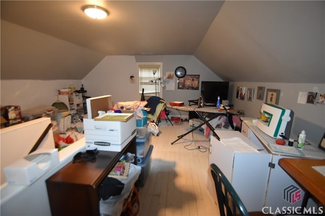 office area with vaulted ceiling and light hardwood / wood-style floors