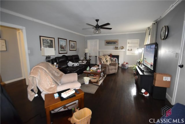 living room featuring crown molding, dark wood-type flooring, and ceiling fan