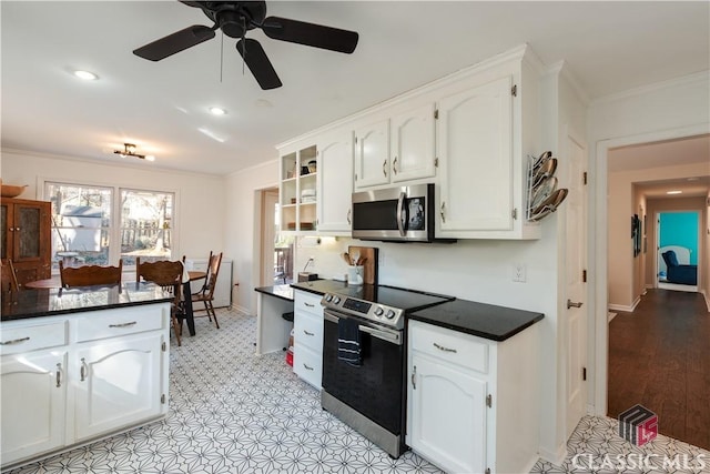 kitchen with stainless steel appliances, crown molding, white cabinets, and ceiling fan