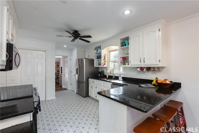 kitchen with sink, white cabinetry, ornamental molding, appliances with stainless steel finishes, and kitchen peninsula