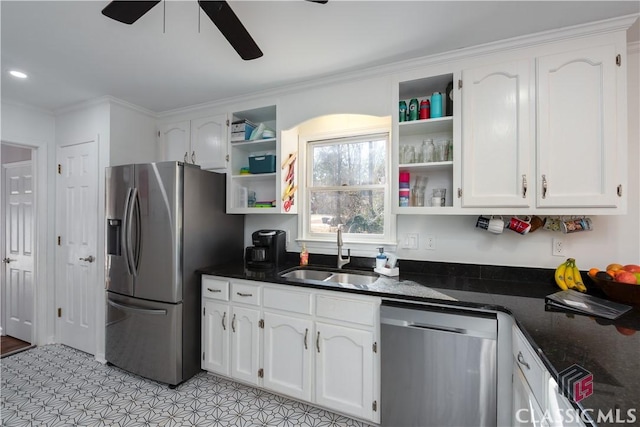 kitchen featuring sink, ceiling fan, stainless steel appliances, white cabinets, and dark stone counters