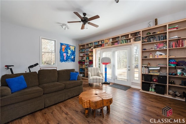 living room with ceiling fan and dark hardwood / wood-style floors