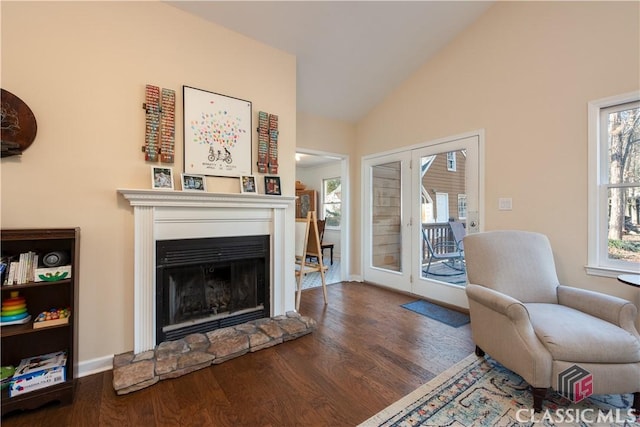 living area featuring vaulted ceiling, dark hardwood / wood-style floors, and french doors