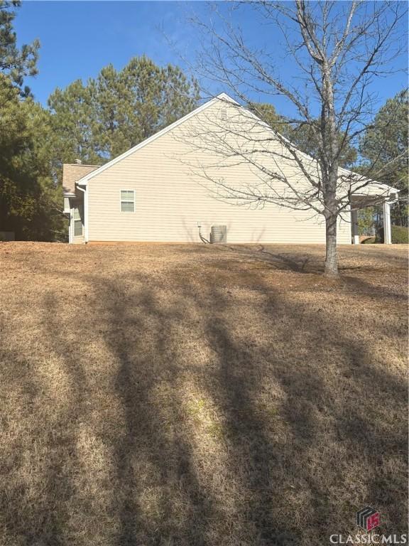 view of side of home with a carport