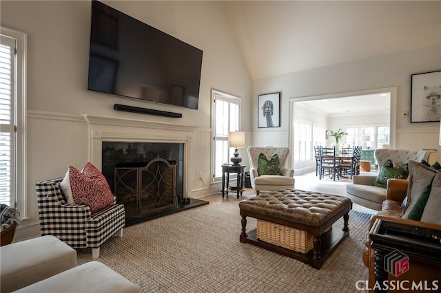 living room with lofted ceiling and a fireplace