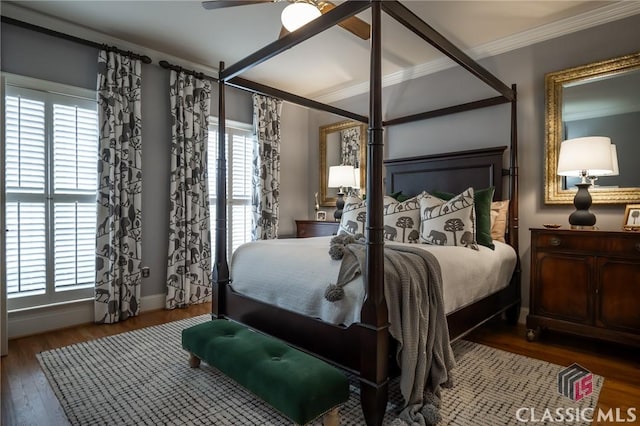 bedroom featuring crown molding, ceiling fan, dark hardwood / wood-style flooring, and multiple windows